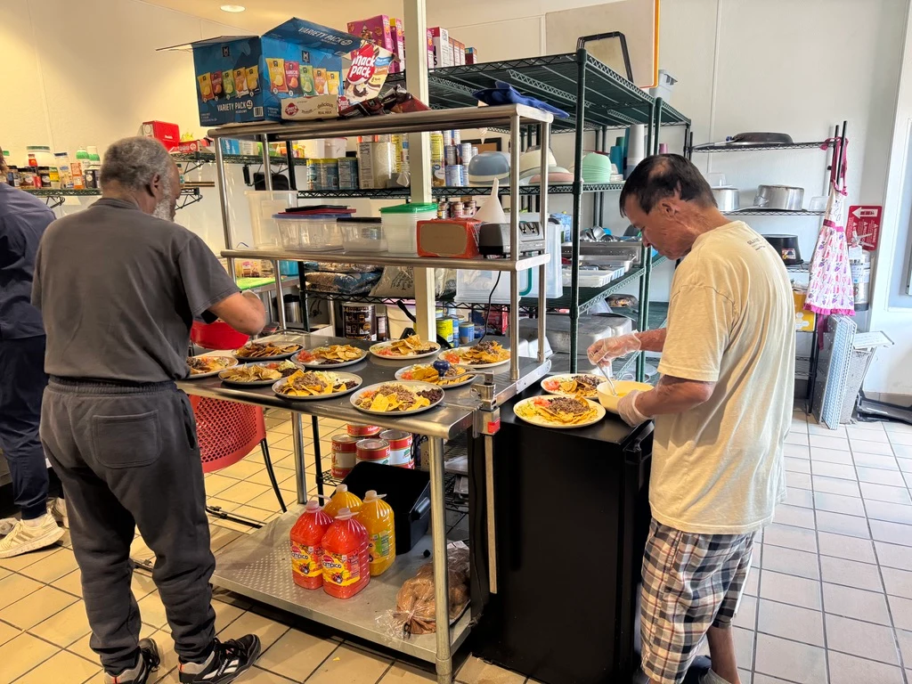 Trinity staff preparing plates of food