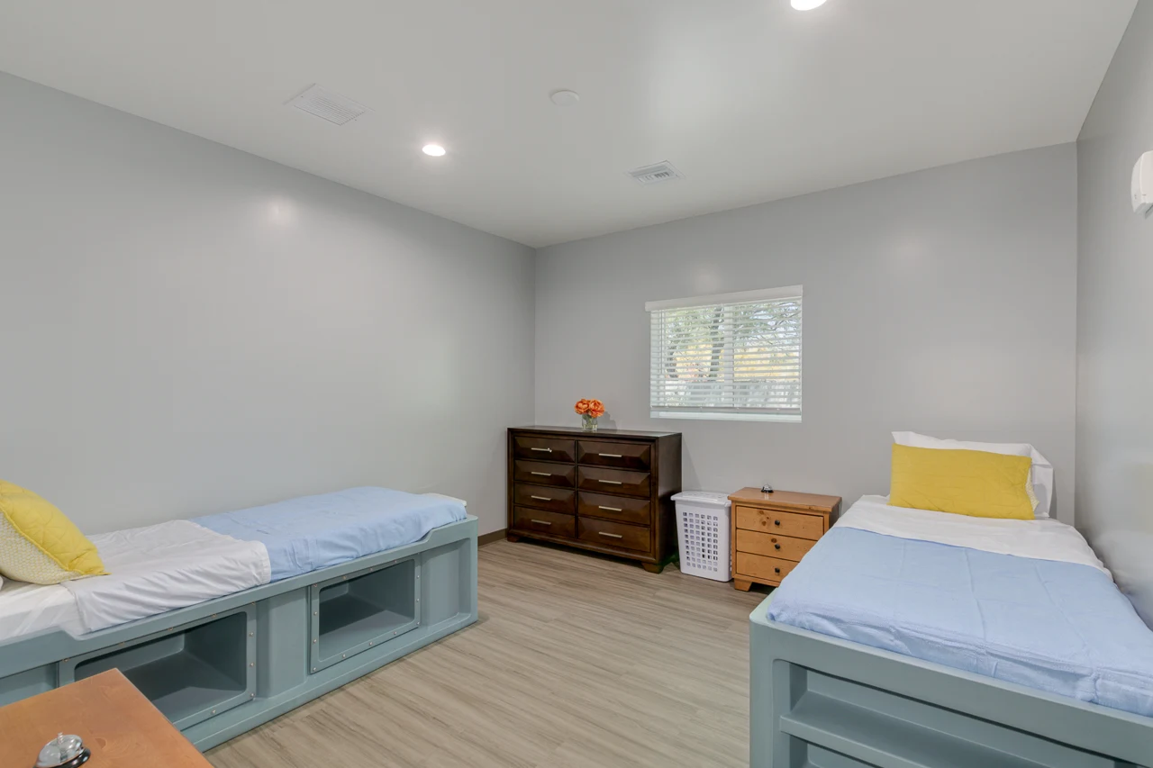 A furnished shared bedroom with two beds